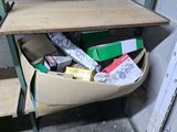a cardboard box filled with assorted items in the corner of a room