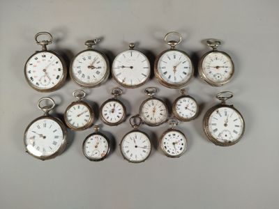 many different types of pocket watches on the table