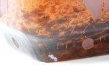 a vase with a brown and white design on it