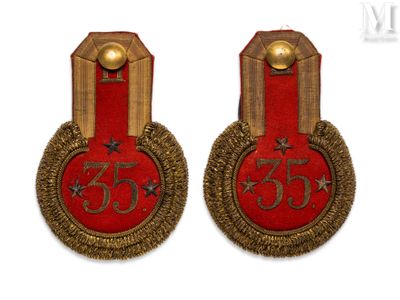 pair of red and gold badges with the number 35 on them