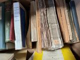many books that are stacked on top of each other