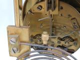 a close up of a clock with a wire attached to it