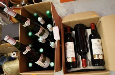 many bottles of wine in a box on the floor