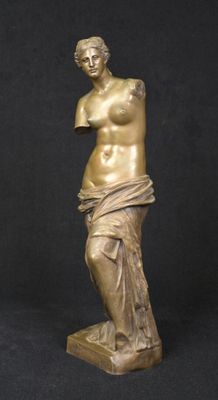 a bronze statue of a woman holding a vase
