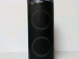 a close up of a black speaker on a white surface