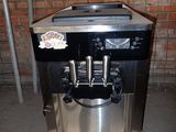 a coffee machine sitting on a pallet in front of a brick wall