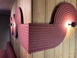 a picture of a wooden wall with two lights on it