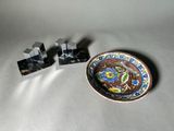 a small plate with a dragon on it next to a small plate with a dragon on it