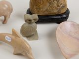 a small collection of animal figurines on a white surface