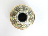a vase that has a black hole in it