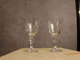 two wine glasses sitting on top of a table