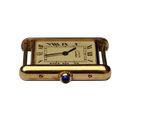 an image of a small gold watch with a blue stone
