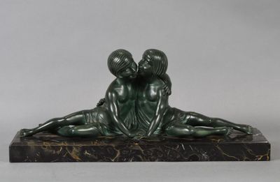 statue of a boy and a girl laying on a marble base