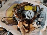 a bag full of tools on the floor next to a pair of scissors and a pair of scissors