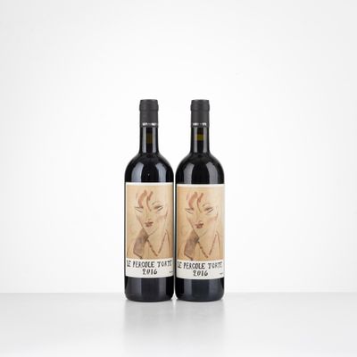 two bottles of wine sitting on top of a table next to each other