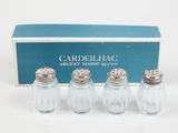 three salt and pepper shakers in a box with a box behind them