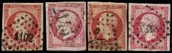 a group of four different colored stamps on a black background