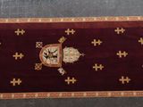 a red rug with a gold cross on it