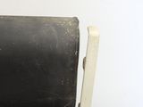 a black seat on a white chair with a black seat