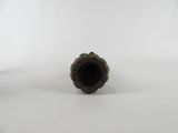 an old metal pipe sitting on top of a white surface