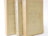 two old books sitting on top of each other on a white surface