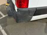 a white van parked in a parking lot next to a curb