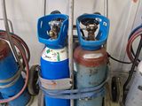 Plusieurs bouteilles de gaz propane sont empilées sur un chariot dans un garage
