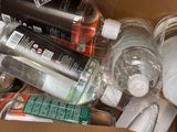a cardboard box filled with bottles of water and toothbrushes