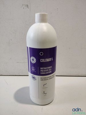 a picture of a bottle of liquid on a table