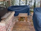une terrasse couverte équipée d'un canapé et d'une table