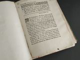 an open book on a table with a black background
