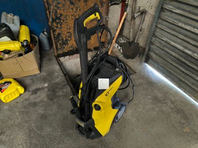 a yellow and black power washer sitting on the floor