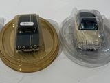 three toy cars sitting on top of each other on a table