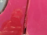 a close up of a pink car with red spots on it