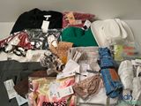 a pile of clothes and other items on a shelf