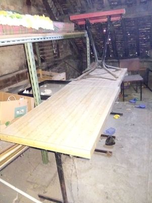 an image of a table in a room with a lot of clutter