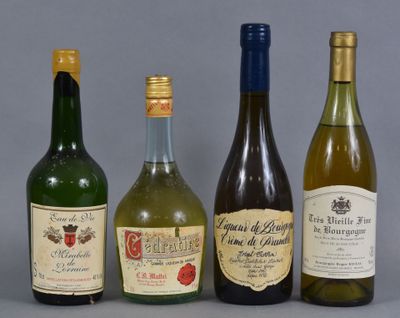 four bottles of wine are lined up in a row on a gray surface