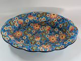 a close up of a blue bowl with flowers on it