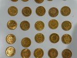 a lot of gold coins that are on the table