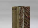 an old book sitting on top of a table covered in snow