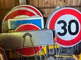 many different signs that are sitting in a garage