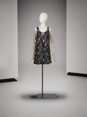 mannequin en robe, posé sur un socle devant un mur blanc