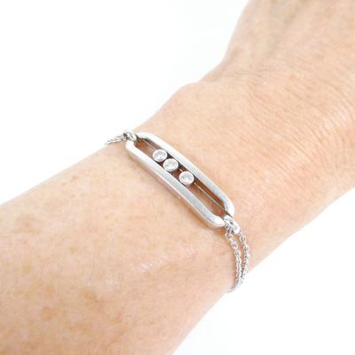bracelet on a woman ' s arm with a chain around it