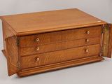an image of a wooden chest of drawers with a door open