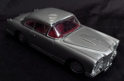 a toy car that is sitting on a black surface