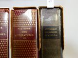 trois vieux livres sont alignés les uns à côté des autres sur une étagère