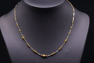 a gold beaded necklace on a mannequin mannequin mannequin mannequin mannequin mannequin mannequin mannequin mann
