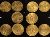 a close up of a bunch of gold coins on a black surface
