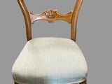 an image of a wooden chair with a blue upholstered seat