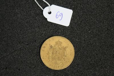 a gold coin on a black surface with a price tag on it